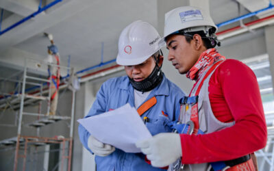 Two construction workers looking at papers
