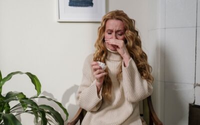 Woman sniffling with a tissue