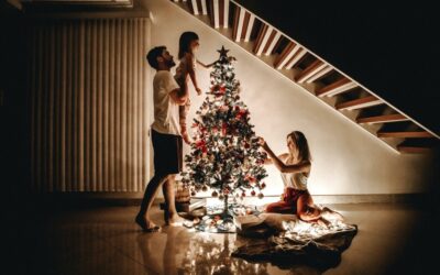 Father, Mother and Daughter putting up a Christmas Tree