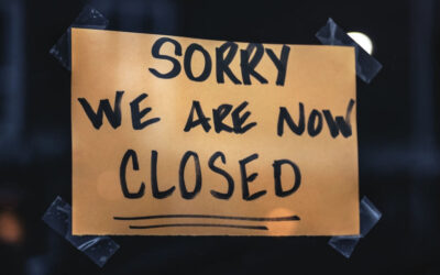 Sign in shop window saying "Sorry We Are Now Closed"