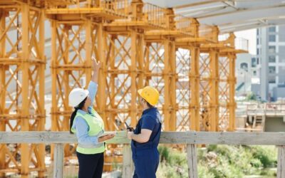 Two people surveying a building site