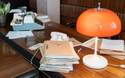 Stack of Files on desk with lamp and typewriter