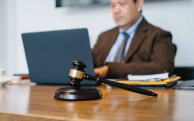 Judge working on their laptop with a gavel on the desk