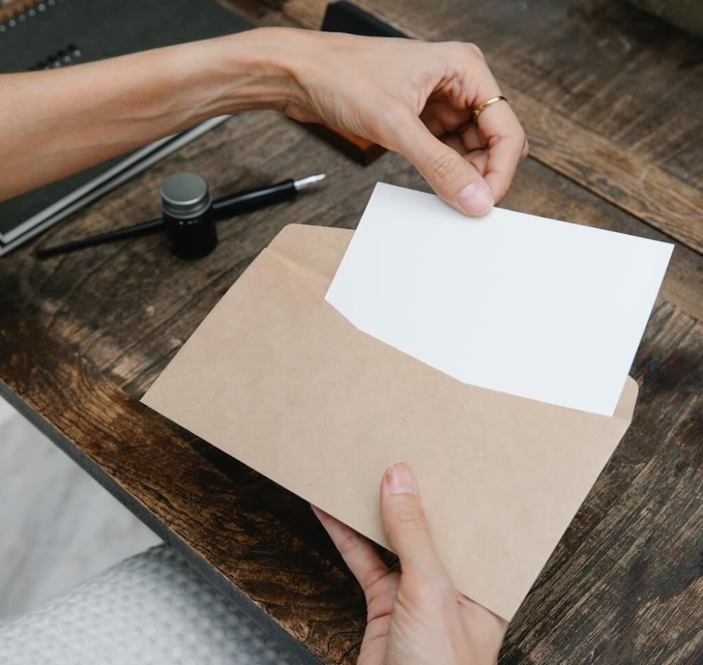 Person taking a letter out of an envelope