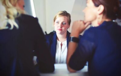 Three smartly dressed women in a meeting