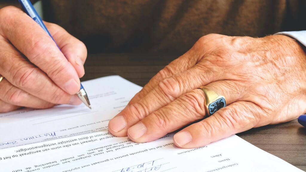 Close up on person signing a contract