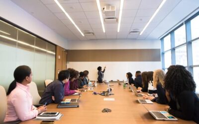A large group of people having a meeting in a board room