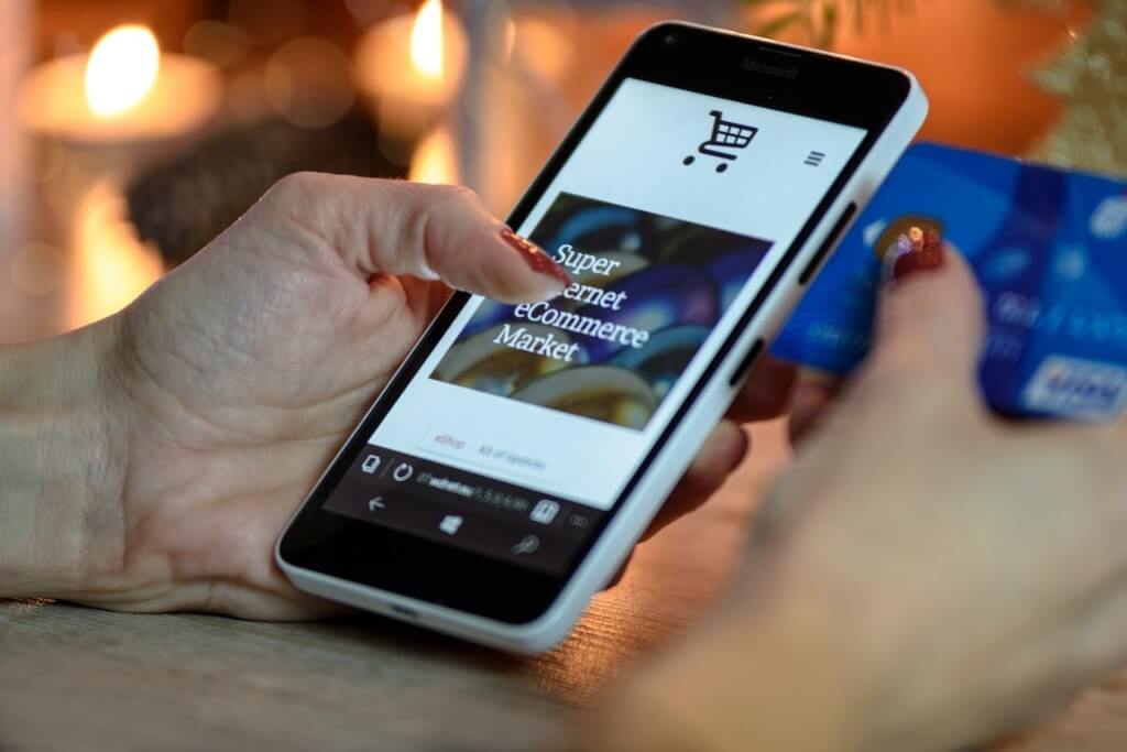 Person imputting their credit card details to an online store