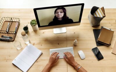 Person working on a computer video calling someone