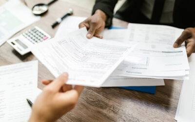 Person handing documents to another