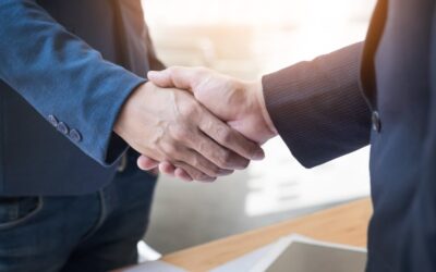 Two people in suits shaking hands