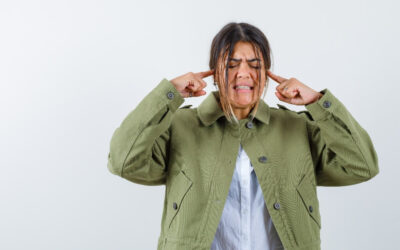 Lady covering her ears from noisy neighbours