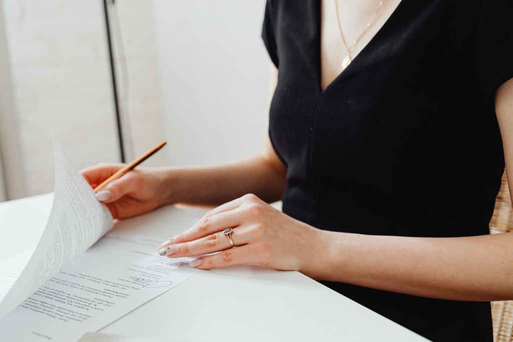 A business woman in black dress reviewing a rectification of contracts