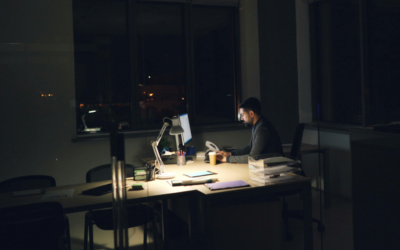 A businessman working late in a dark office